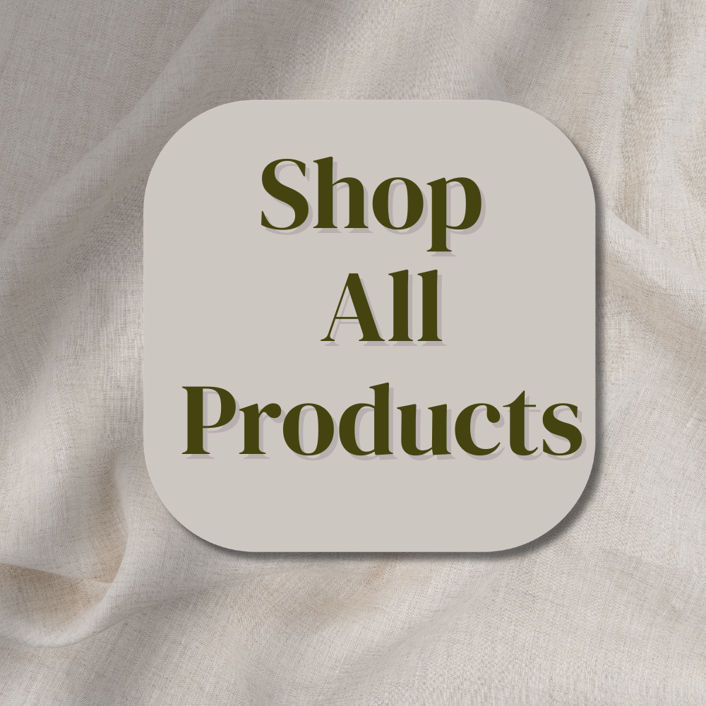 Crochet headbands in four different colors: purple, blue, white, and pink laying on the white surface with some spring flowers by the side