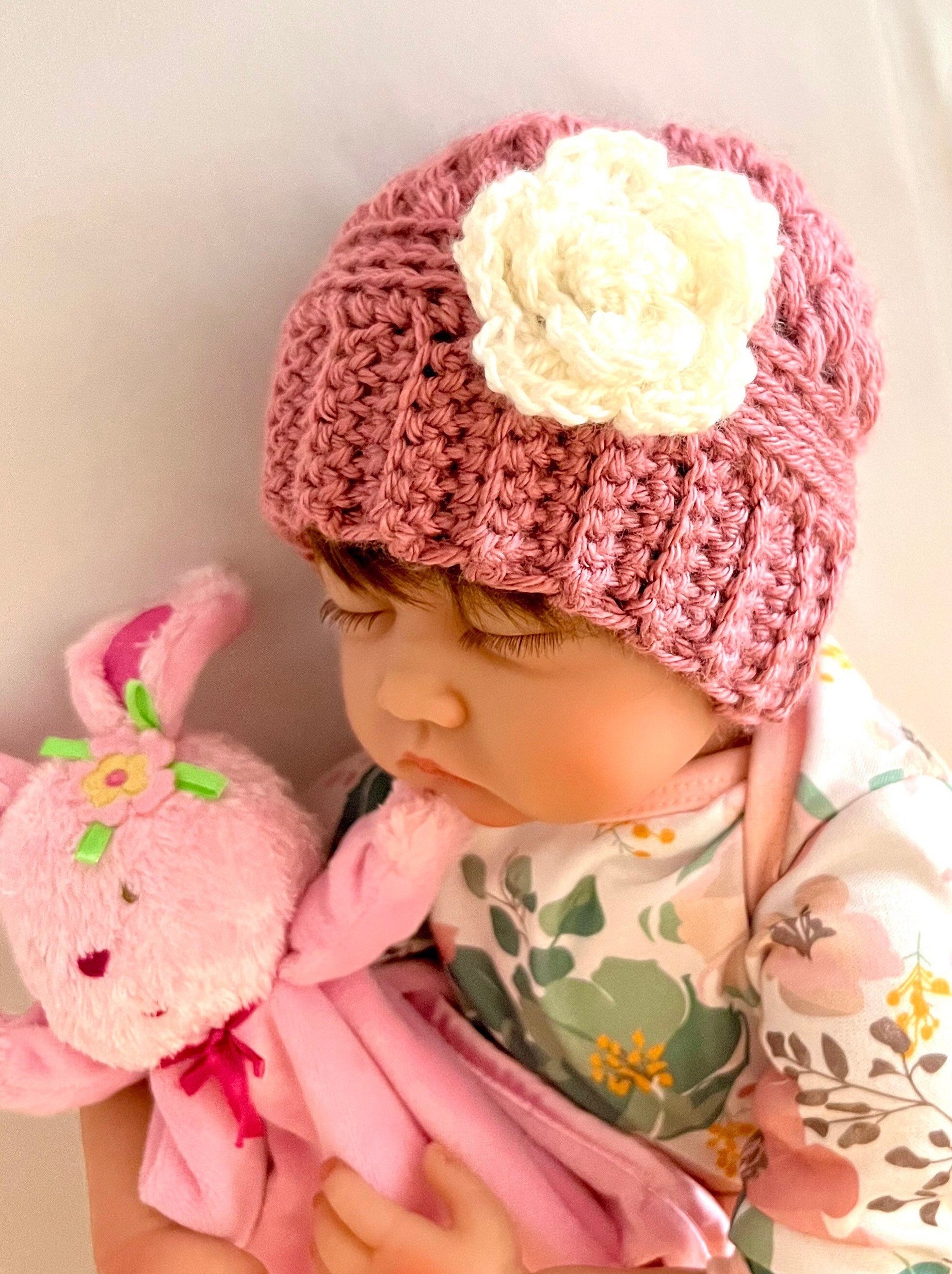 May include: A pink crocheted hat with a white crocheted flower on top.
Handmade Crochet Baby Beanie Flower Detail Winter Cap Stretchy Soft Acrylic Yarn Ribbed Pattern Design Newborn Size Warm Head Cover Baby Shower Gift Perfect Photo Prop Beautiful Handcrafted Quality Infant Accessory Comfortable Fit Winter