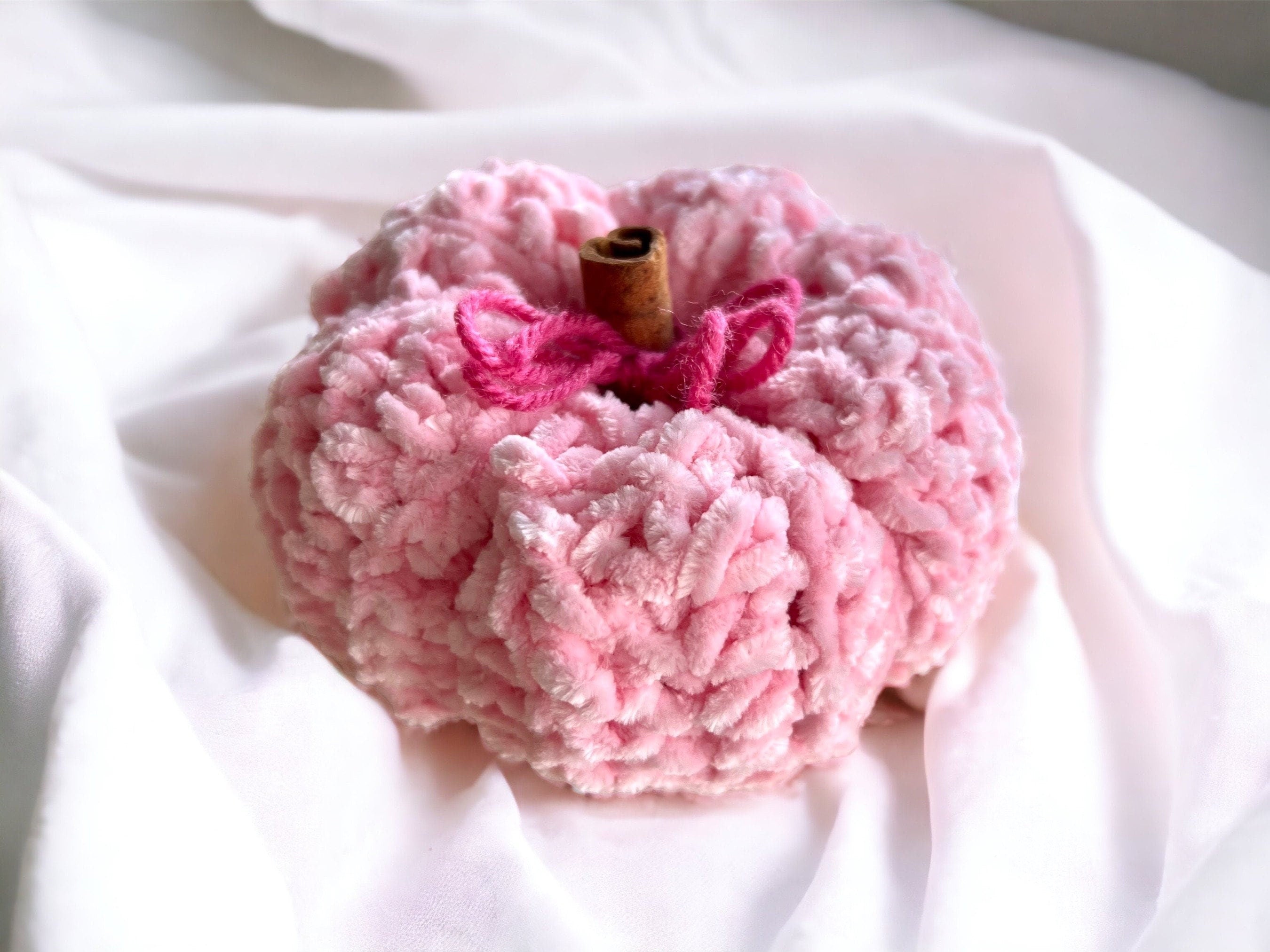 Plush Pink pumpkin decorative with cinnamon stick stem for touch of warmth