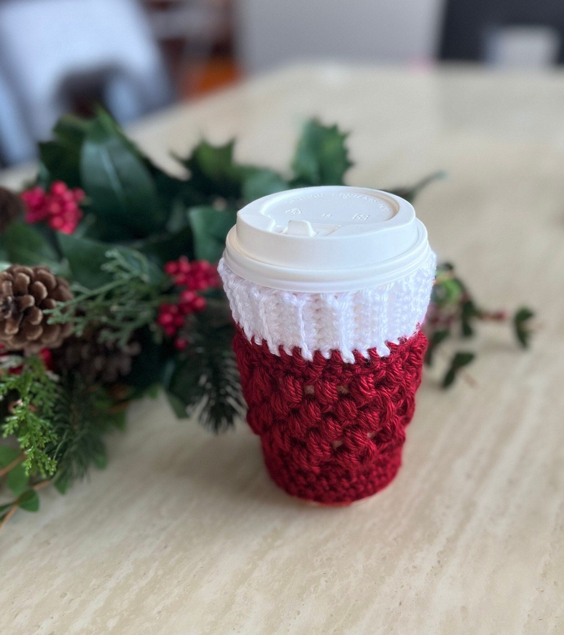 https://lillygracesparkle.com/cdn/shop/products/holiday-edition-crochet-coffee-cozy-red-and-white-christmas-drink-cozy-490498.jpg?v=1678944924&width=1946